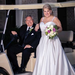 Mr and Mrs Gallagher wedding picture on a golf cart